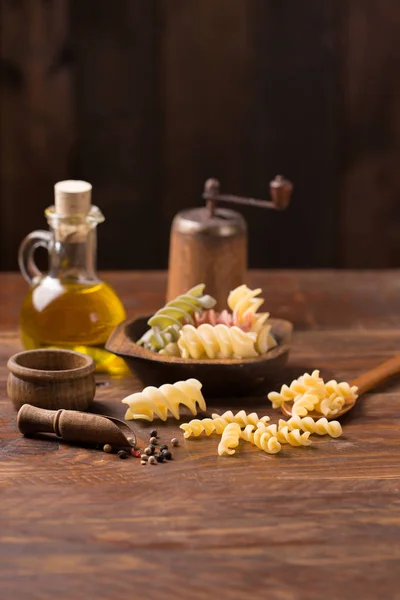 Fusilli pasta on rustic  wooden background — Stock Photo, Image