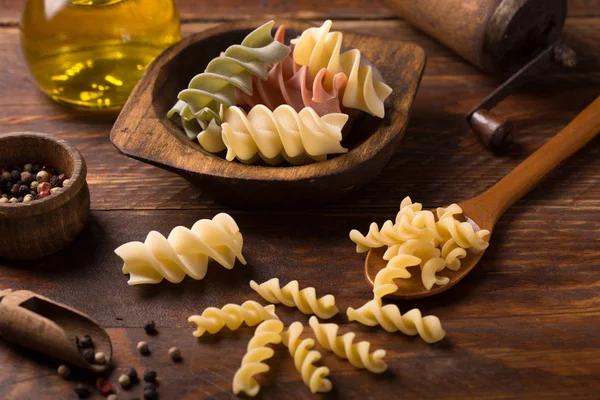 Fusilli pasta on rustic  wooden background — Stock Photo, Image