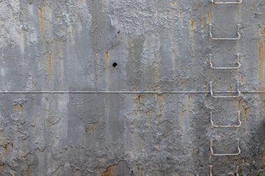 Demir merdiveni olan eski bir savaş gemisinin paslı tarafı