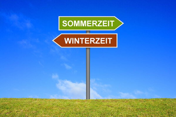 Signpost showing summer and winter time german