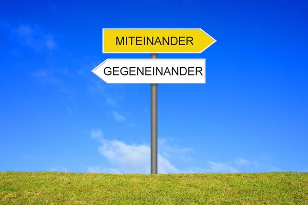 Signpost showing Together or Against each other german — Stock Photo, Image