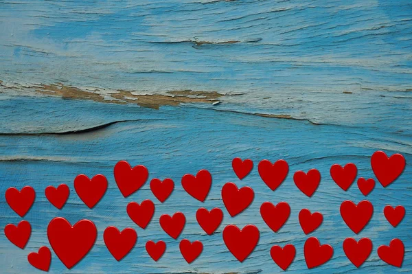 Alte hellblaue Holzplanke mit roten Herzen — Stockfoto