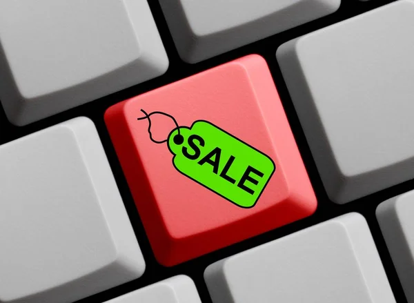Комп'ютерна клавіатура з міткою, що показує продаж — стокове фото