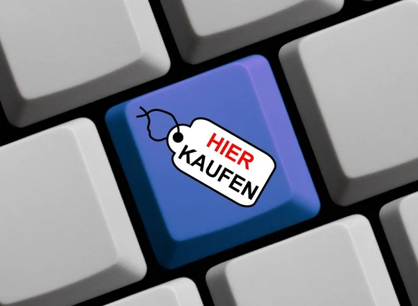Computer keyboard with tag showing Buy Here in german language — Stock Photo, Image