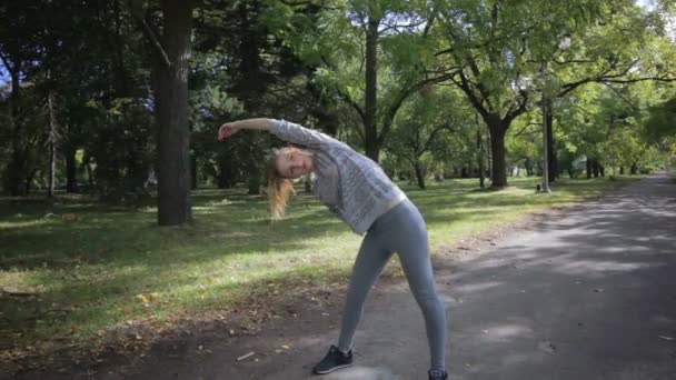 Девушка делает упражнения со склонами — стоковое видео