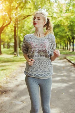 Genç kızla mavi gözleri bir parkta yürüyüş