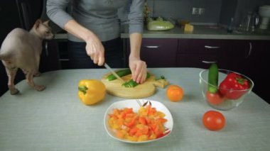 Kız cook dilimlenmiş salatalık mutfakta hazırlar