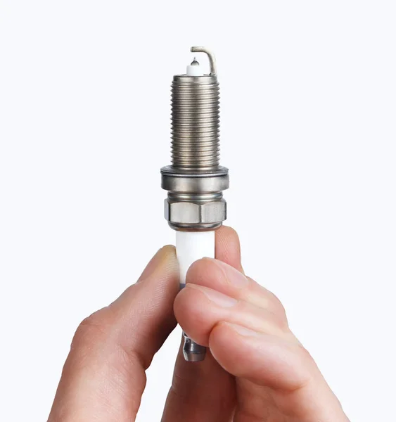 Mechanic holds a spare part spark plug in hand — Stock Photo, Image