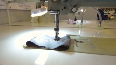 Needle with thread for sewing clothes.
