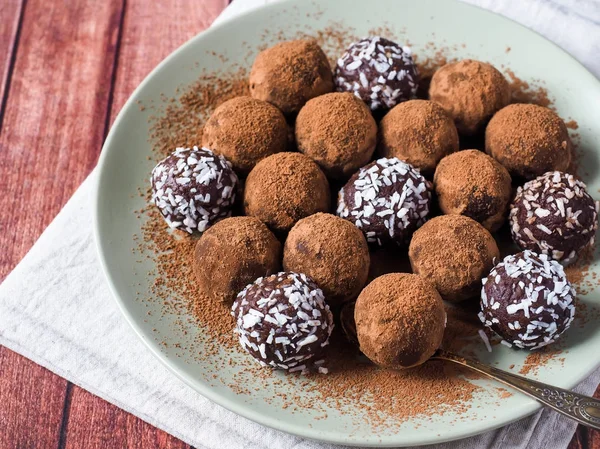 Trufas de chocolate caseiro com cacau e coco no prato — Fotografia de Stock