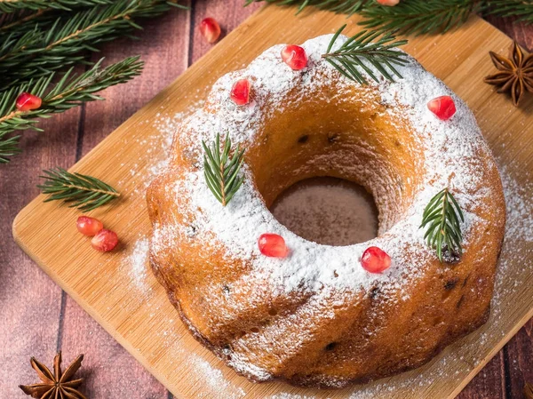 Gâteau de Noël en forme de couronne avec des décorations de Noël. Grenade anis étoile sapin branches . — Photo
