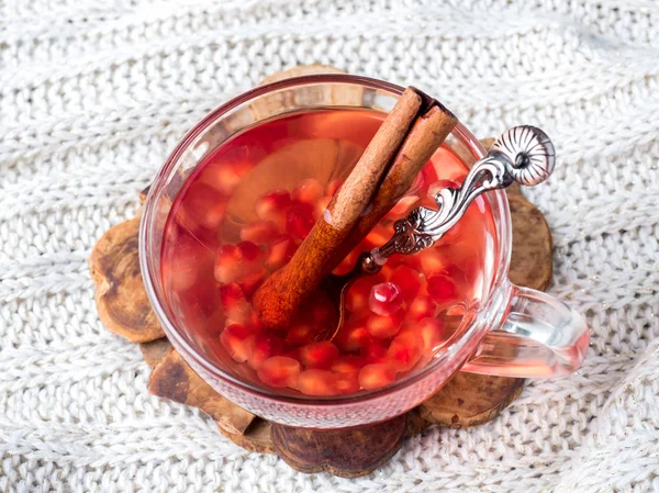 Fresh ripe pomegranate and red wine in a glass mug on a white knitted blanket — Stock Photo, Image