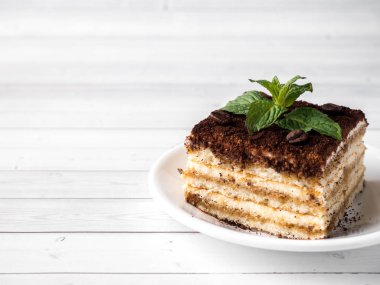 Tiramisu tatlı nane ve fincan kahve Beyaz ahşap tablo kopyalama alanı