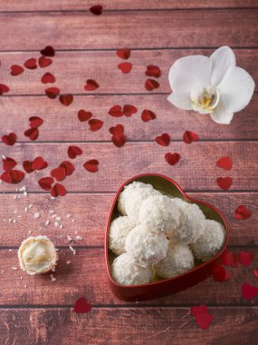Hindistan cevizi şeker kırmızı kalp orkide çiçek ahşap arka plan kopya alanı içinde