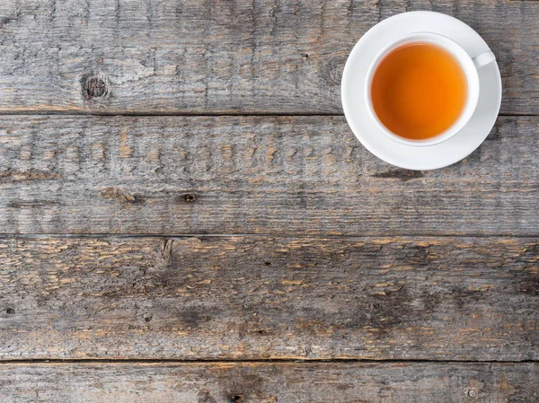 Tazza di tè bianco e piattino su uno sfondo in legno rustico Copia spazio — Foto Stock