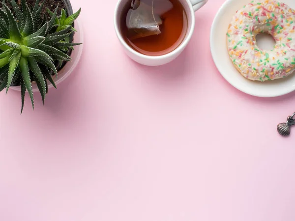 Flat lay Coffee Cup Donut Cactus Pencil Watch Player Vanilla on a Pink background — стоковое фото