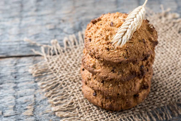 Oatmeal cereal cookies on napkin burlap wood table — Stock Photo, Image