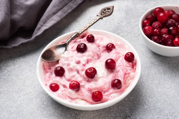 Cottage cheese dessert of yogurt jam and cranberries on a plate. grey concrete table. Concept healthy useful Breakfast. Copy space. Stock Photo