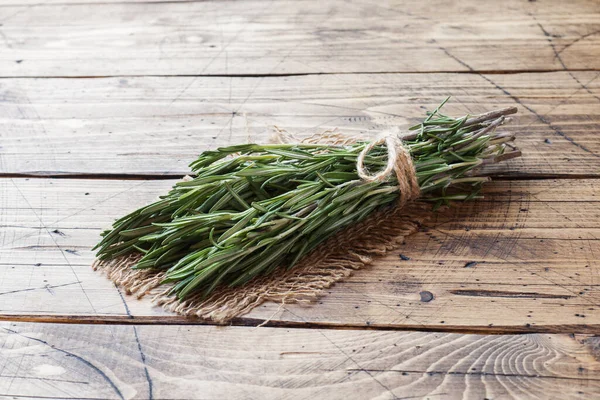 stock image Bunch of fresh rosemary on wooden background. Copy space.