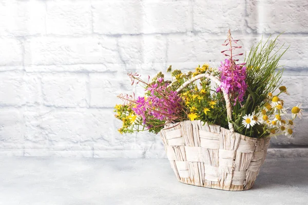Bouquet of beautiful wildflowers in a basket on a gray background with copy space — Stock Image Bouquet Beautiful Wildflowers Basket Gray Background Copy Space Royalty Free Stock Photos