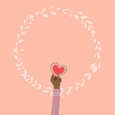 Sevgililer günü için kalp kurabiye tutan el