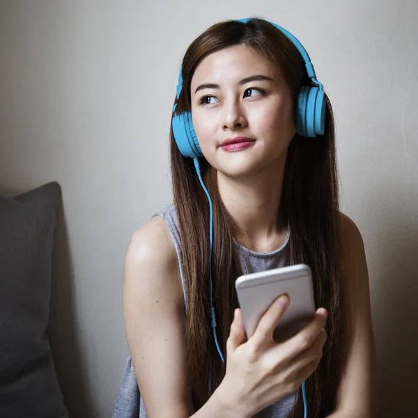 Jeune asiatique femme écoute musique — Photo