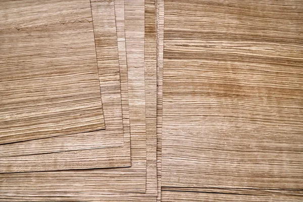 Oak veneer. Oak texture. Spliced oak veneer on the table in the workshop. Close-up