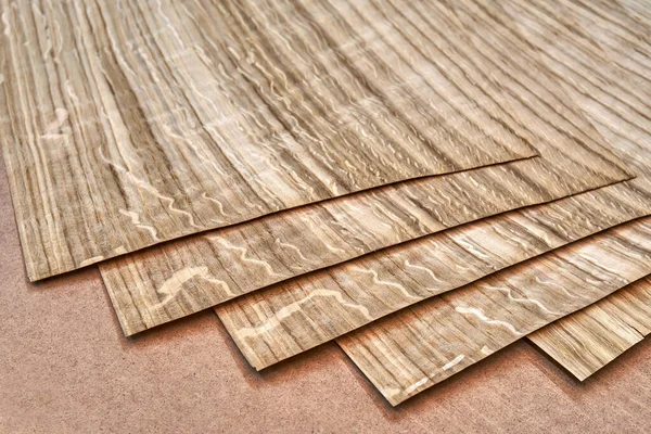 Oak veneer. Oak texture. Spliced oak veneer on the table in the workshop. Close-up