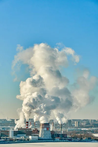 Dense steam escaping from a thermal power plant. Thermal power station on a frosty day