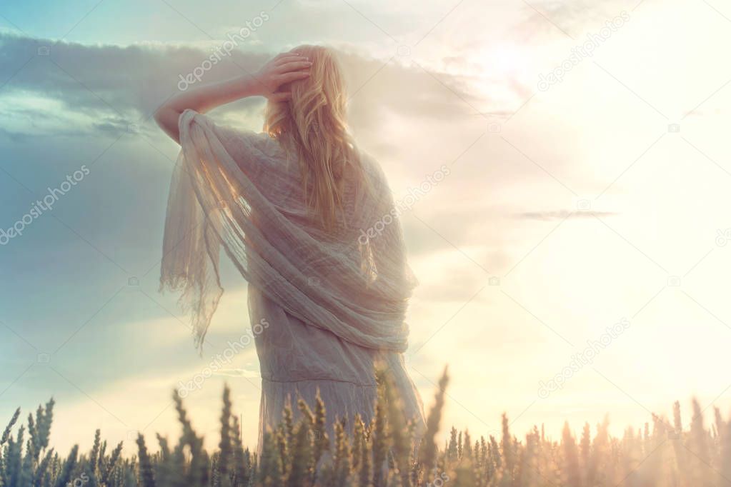 dreamy woman looks at infinity as the sun rises