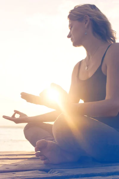 Vrouw in meditatie wordt verlicht door de ochtendzon — Stockfoto