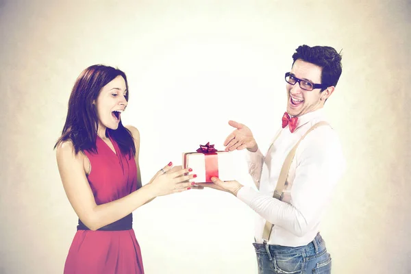 Funny Valentine's Day, satisfied guy  giving special gift to his girlfriend
