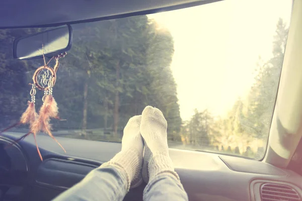 Avslappnad person med fötterna på instrumentpanelen under bilresa — Stockfoto