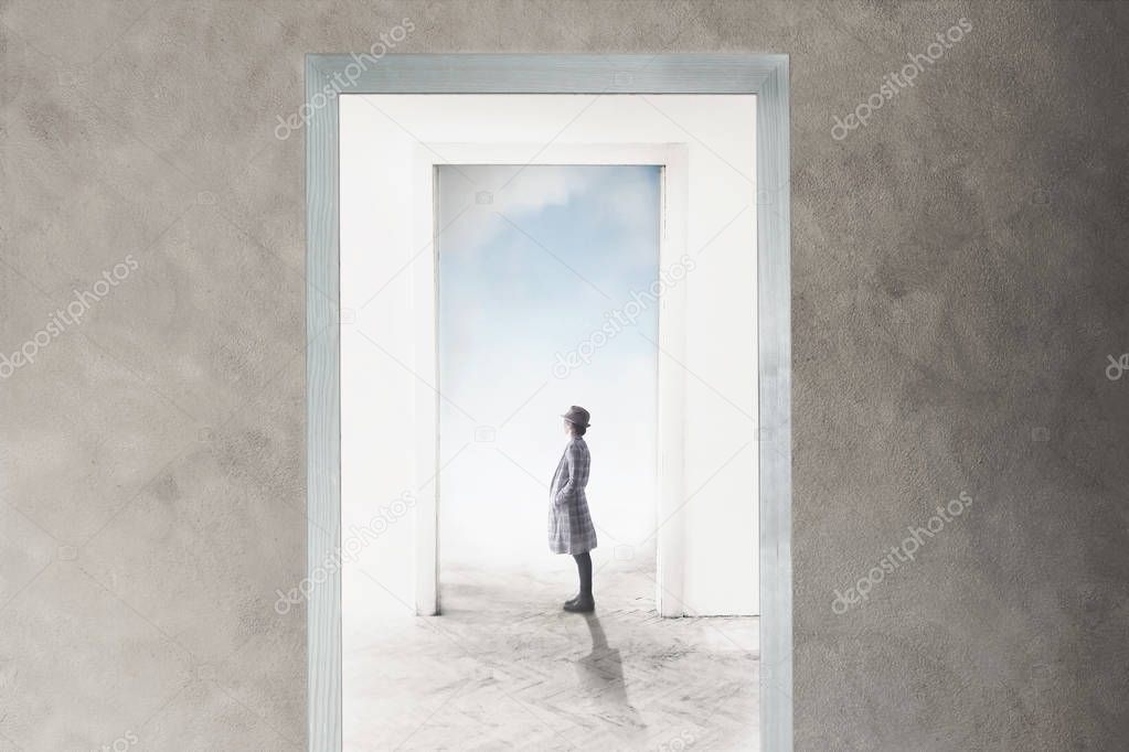 woman observe curious the door that opens towards freedom and dreams