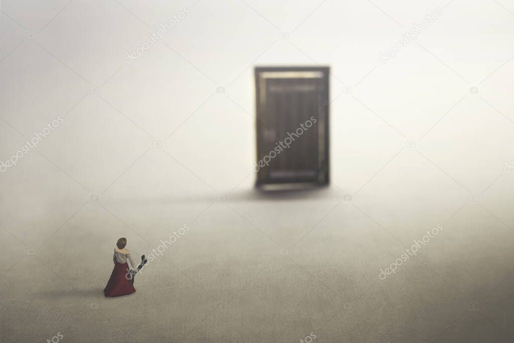 small woman carries the key to open the door, concept of freedom