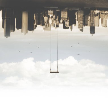 surreal swing hanging upside down compared to the metropolis clipart