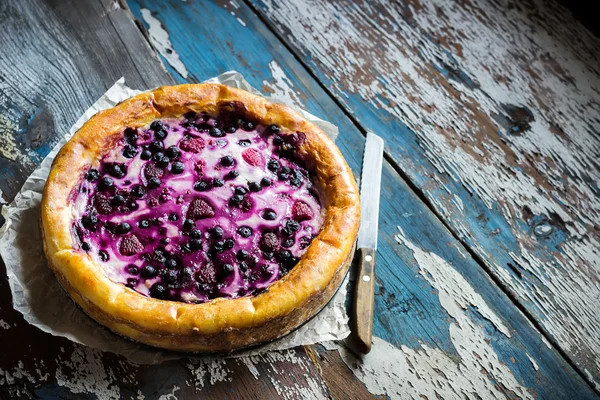 Homemade pie with bilberry on old wooden table. — Stock Photo, Image