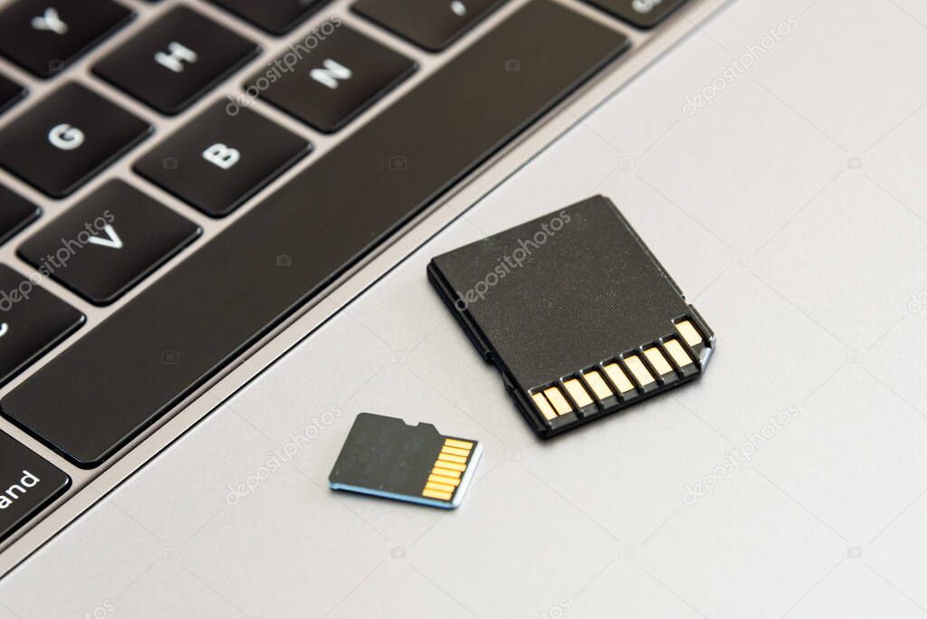 An SD card and micro SD card on a laptop computer. 