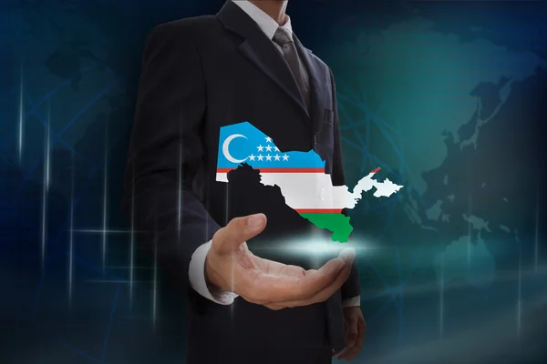 Businessman with map and flag of Uzbekistan — Stock Photo, Image