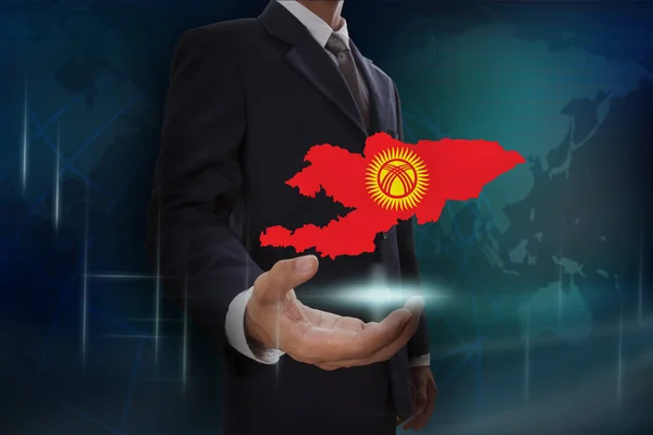 Biznesmen z mapą i flagę, Kirgistanu — Zdjęcie stockowe