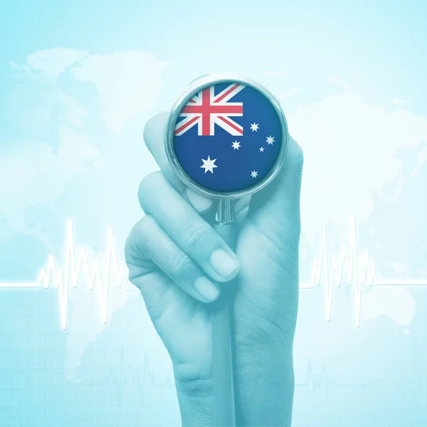 Hand of doctor holding stethoscope with Australia flag. — Stock Photo, Image