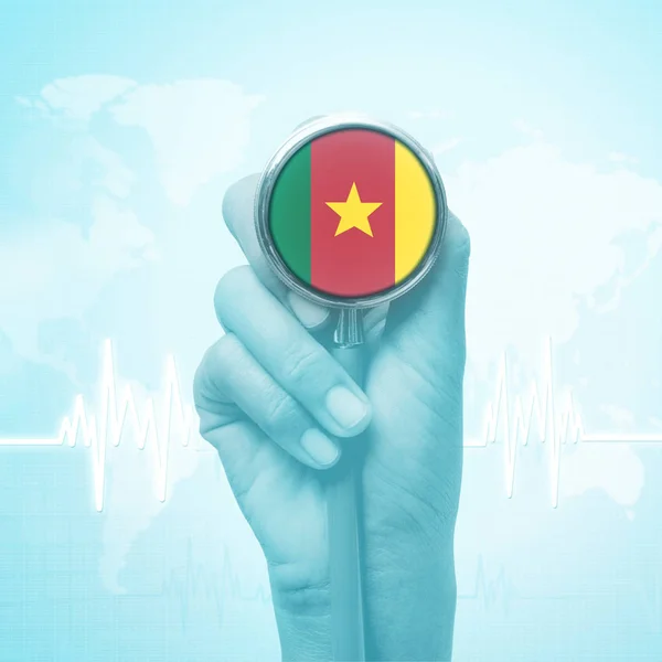 Hand of doctor holding stethoscope with Cameroon flag. — Stock Photo, Image
