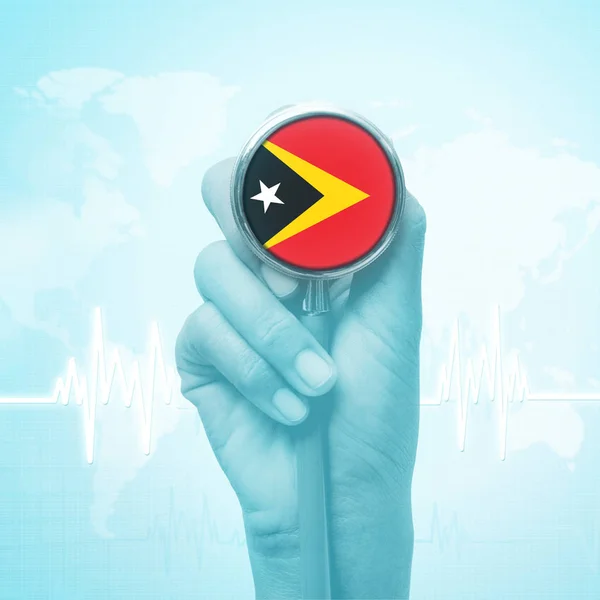 Hand holding stethoscope with East Timor flag. — Stock Photo, Image