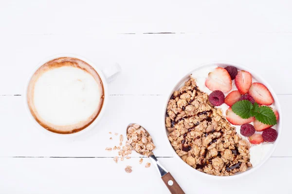 Havremjöl müsli till frukost med bär, yoghurt och choklad på vit trä bakgrund. Sunda matvanor — Stockfoto