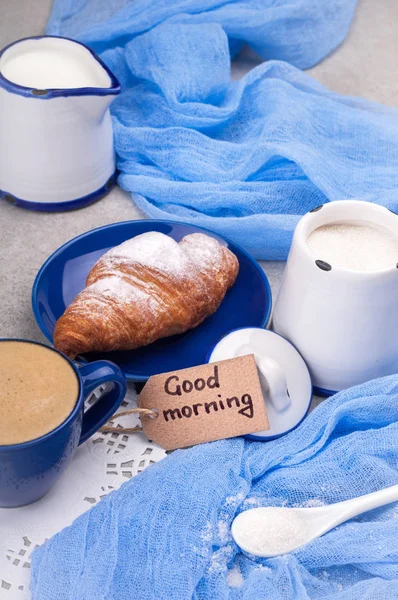 Traditional breakfast with croissants, yogurt and coffee cup. Concept tasty and cozy breakfast