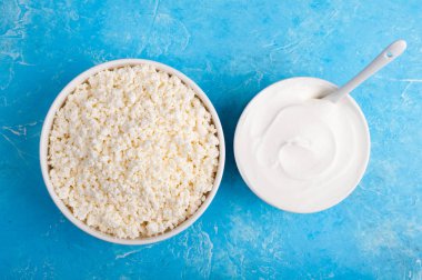 Mavi zemin üzerine süt ürünleri. Yoğurt, ekşi krema, peynir. Sağlıklı gıda ve beslenme kavramı