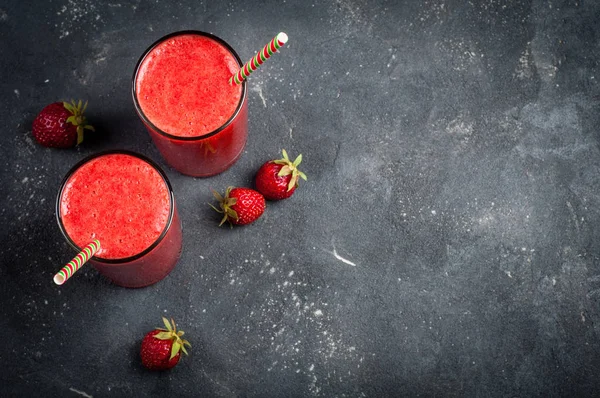 Smoothie aux fraises en verre sur fond sombre avec espace de copie. Cocktail d'été. Régime alimentaire sain et concept de petit déjeuner — Photo