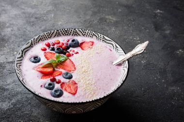 Çilek, çilek, yaban mersini, kızılcık, kuş üzümü ile smoothies kase. Pembe yüzlü portre. Sağlıklı gıda ve beslenme