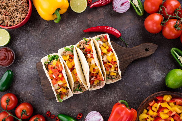 Mexican tacos with vegetables and meat. Ingredient for cooking tacos al pastor on concrete background