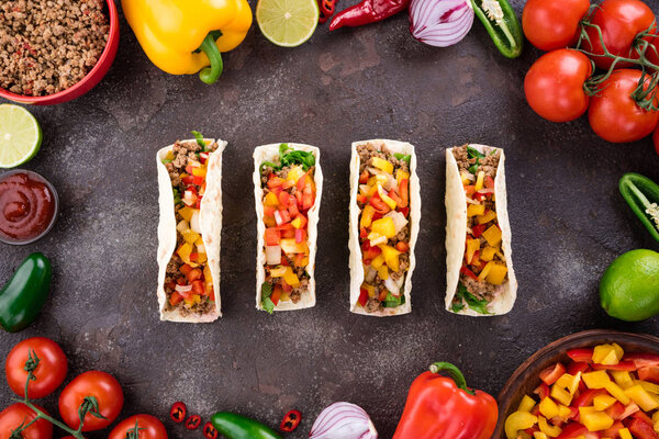 Mexican tacos with vegetables and meat. Ingredient for cooking tacos al pastor on concrete background